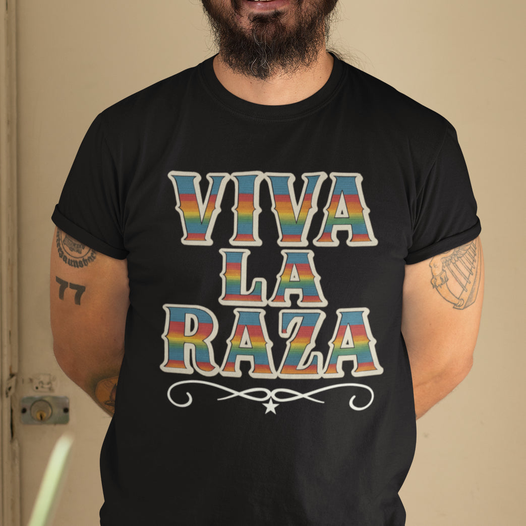 Person wearing a black t-shirt with 'VIVA LA RAZA' in colorful letters.